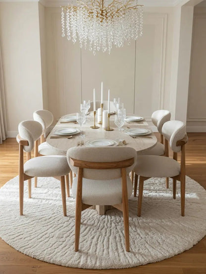 Table à manger ovale en travertin avec chaises bouclette - Modernista Maroc