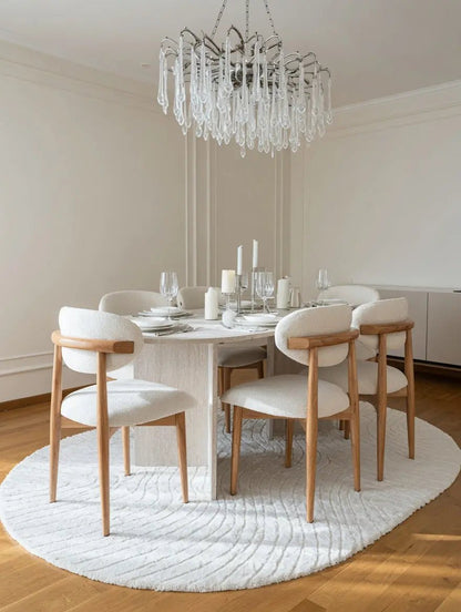 Table à manger ovale en travertin avec chaises bouclette - Modernista Maroc